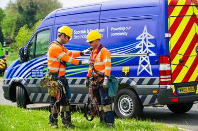 Engineers in high vis standing outside of van