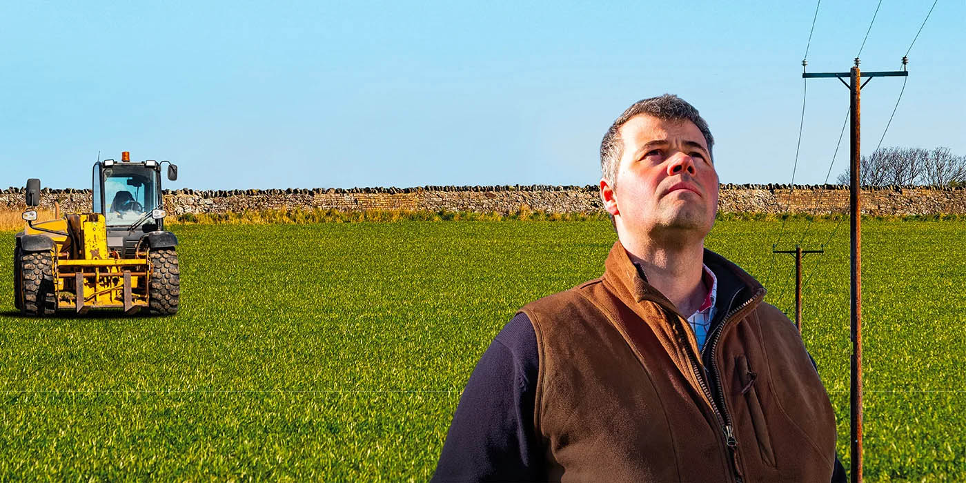 Farmer looking up at overhead network.