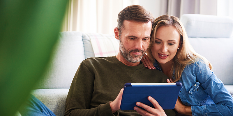 Man and woman looking at tablet 