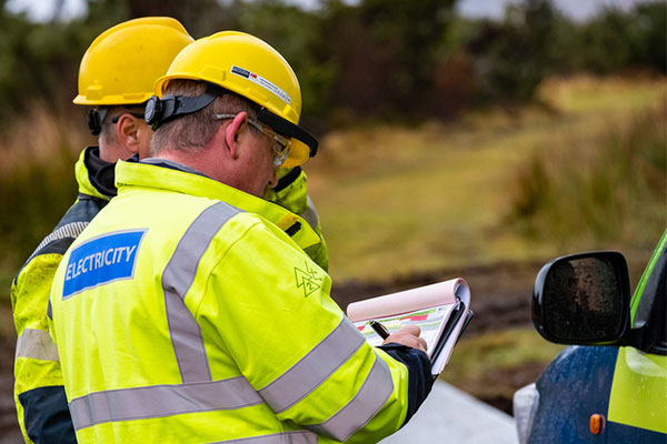 Two ssen engineers looking at clip board