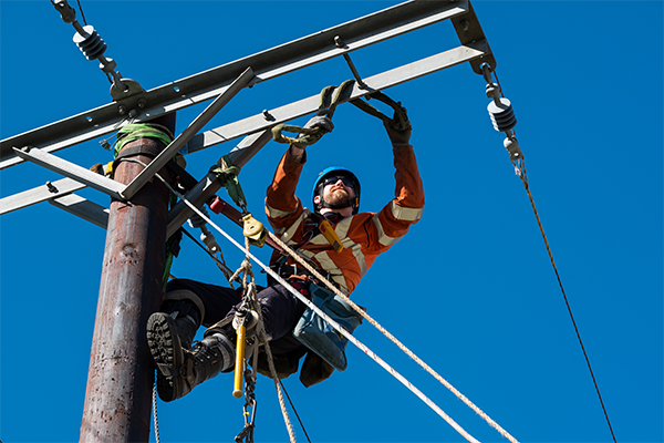 Picture shows; linesman working on overhead lines